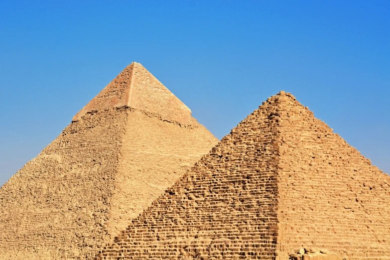 a group of three tall tan pyramids next to each other