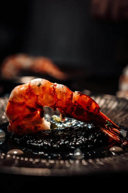 a plate with a cooked shrimp on it