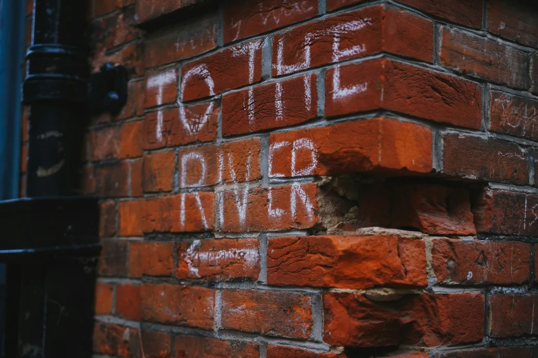 brick wall with graffiti reading hole in the middle and small opening