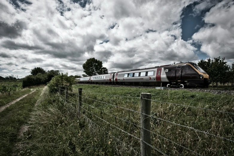 an amtrak train traveling down the tracks through countryside