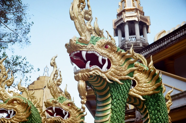 some ornately designed dragon sculptures with spires