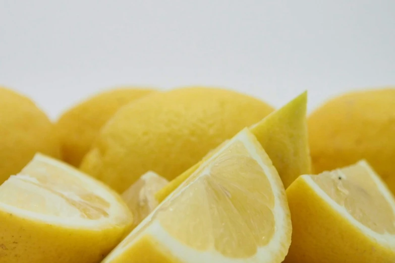 a white surface containing several yellow lemons