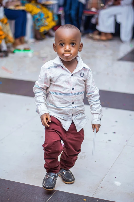 little boy standing on the street, holding an umbrella