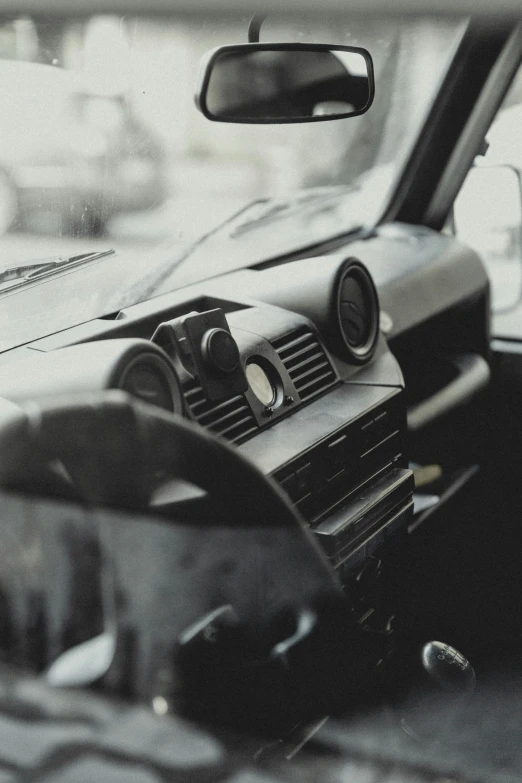 the dashboard of an automobile in black and white