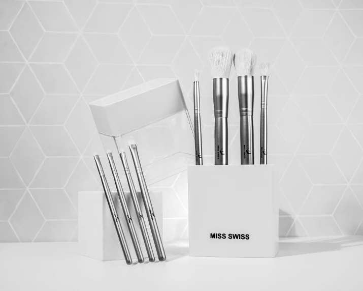black and white pograph of brushes and white envelopes