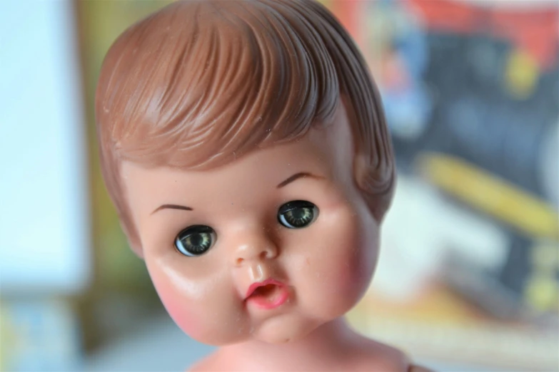 a close up of an old fashion boy doll