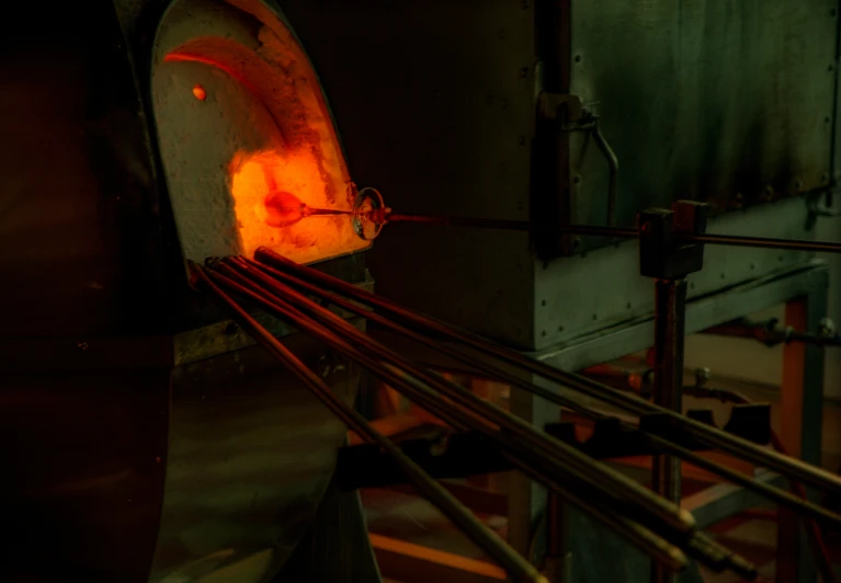 a worker with a machine that is pouring soing into a bowl