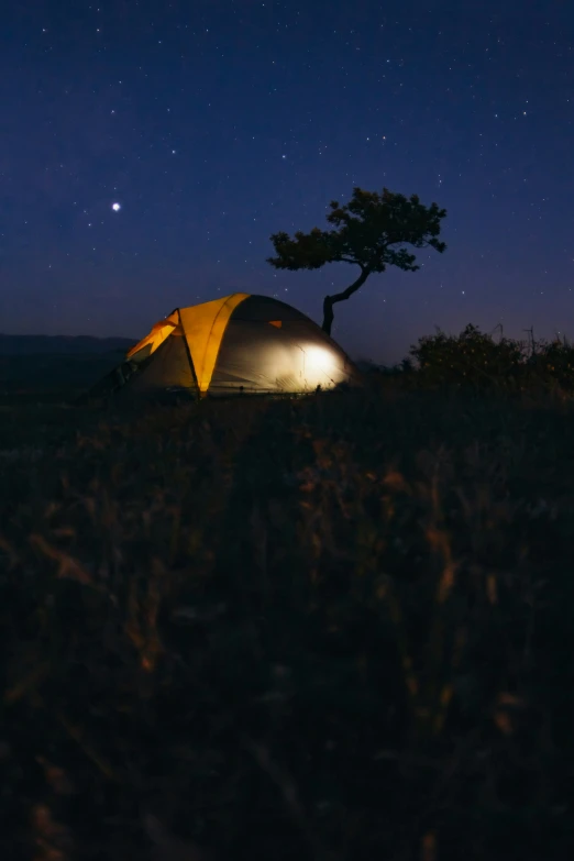 a tent at night with the stars above it