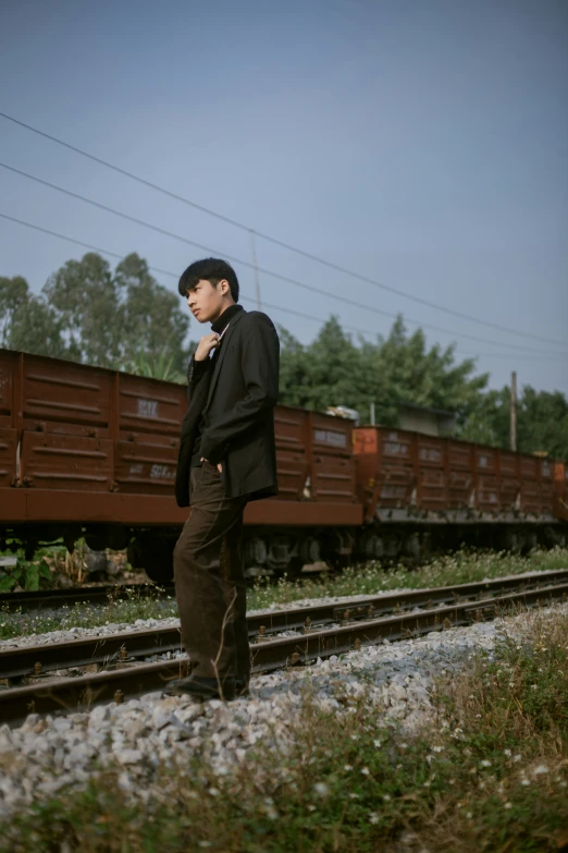 a person is standing next to a train