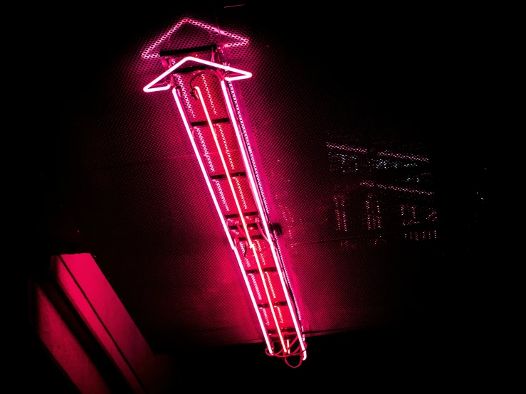 a neon sign sitting on top of a wooden shelf