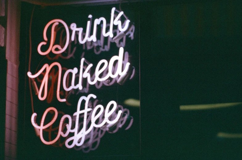 a restaurant sign with neon text saying drinks are  coffee