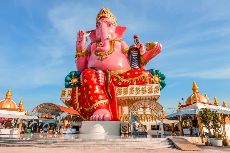 a large pink statue with many decorations on it