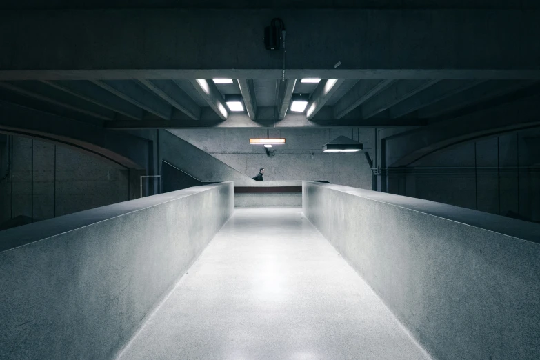 a cement wall with spotlights in an empty space