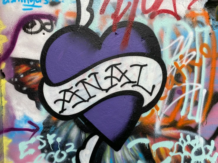 graffiti that is covering a wall with a heart