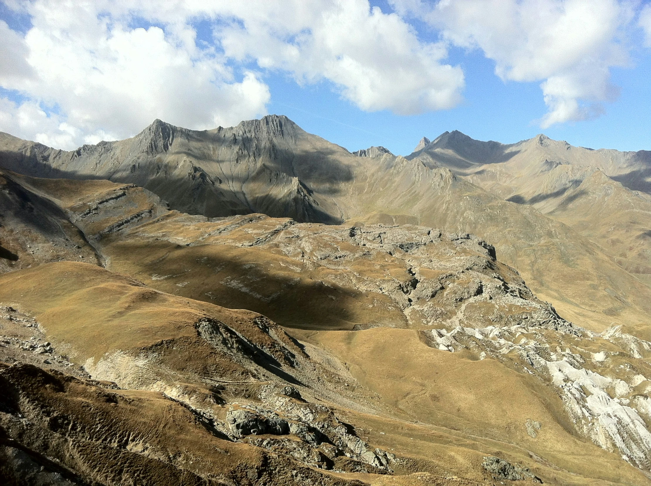 an aerial view of a hill and mountains