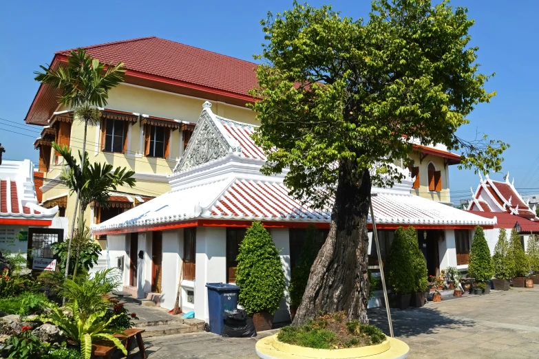 two storyed houses with a red and white roof