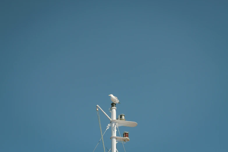 the sky is clear with white wires connected to a building's structure