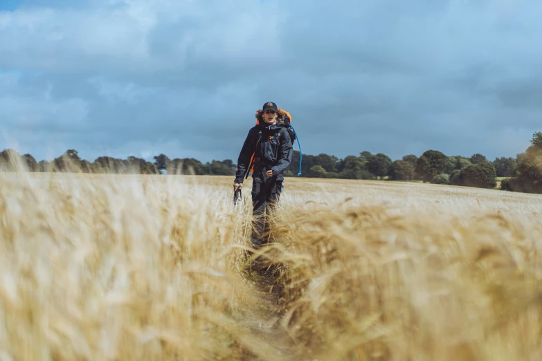 two people on their skis walk through some tall grass