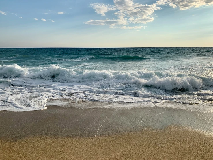 the beach has been sanded up with white foamy waves