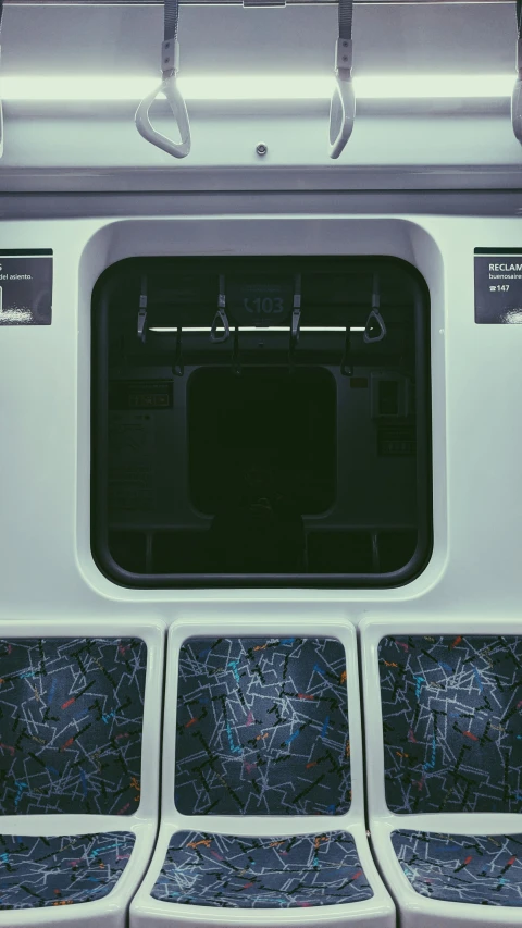 seats with the back side of a bus showing two large doors