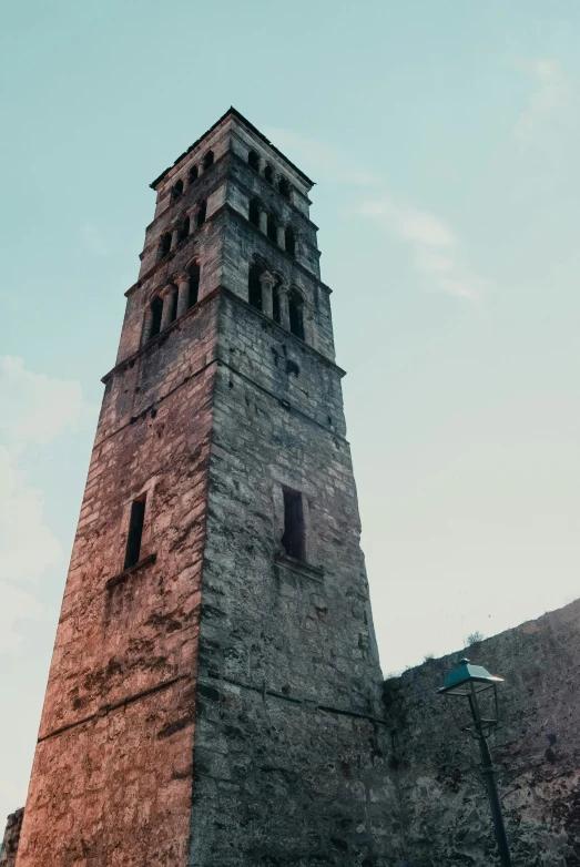this stone clock tower is built over an old wall