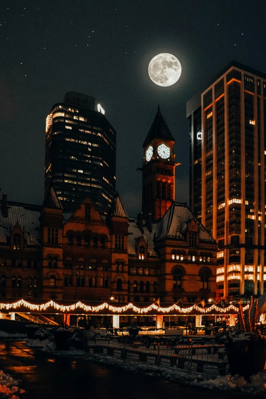 a very large tower and some lights near a river