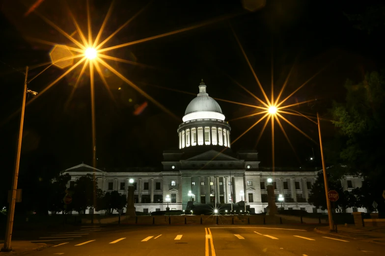 the state capitol building at night with street lights