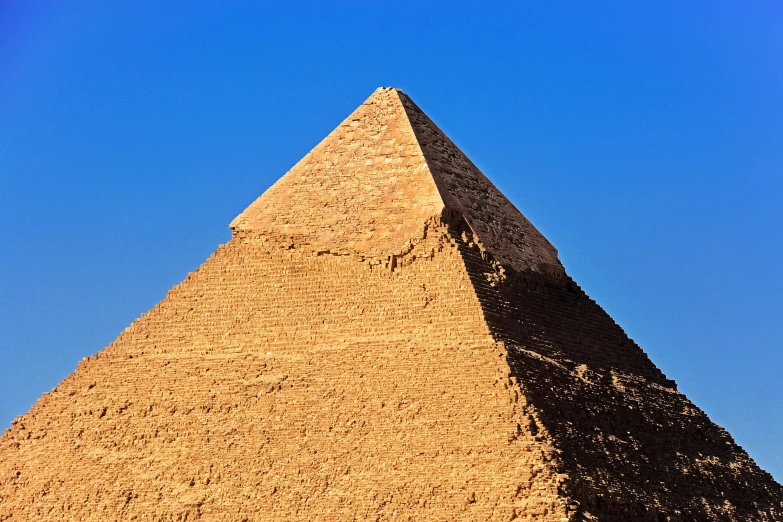 a large pyramid is shown against a blue sky