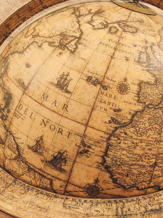 an antique globe is sitting on the table