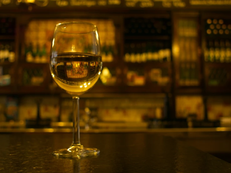 a glass of wine sitting on a counter