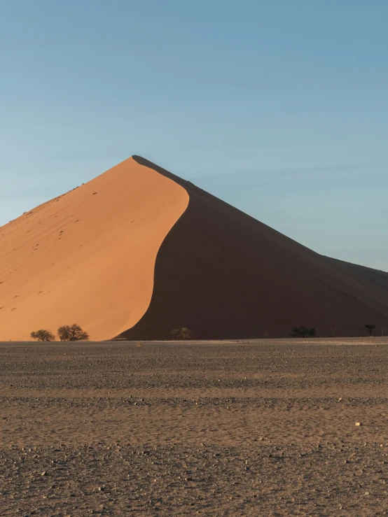 an empty desert field near a hill and dirt