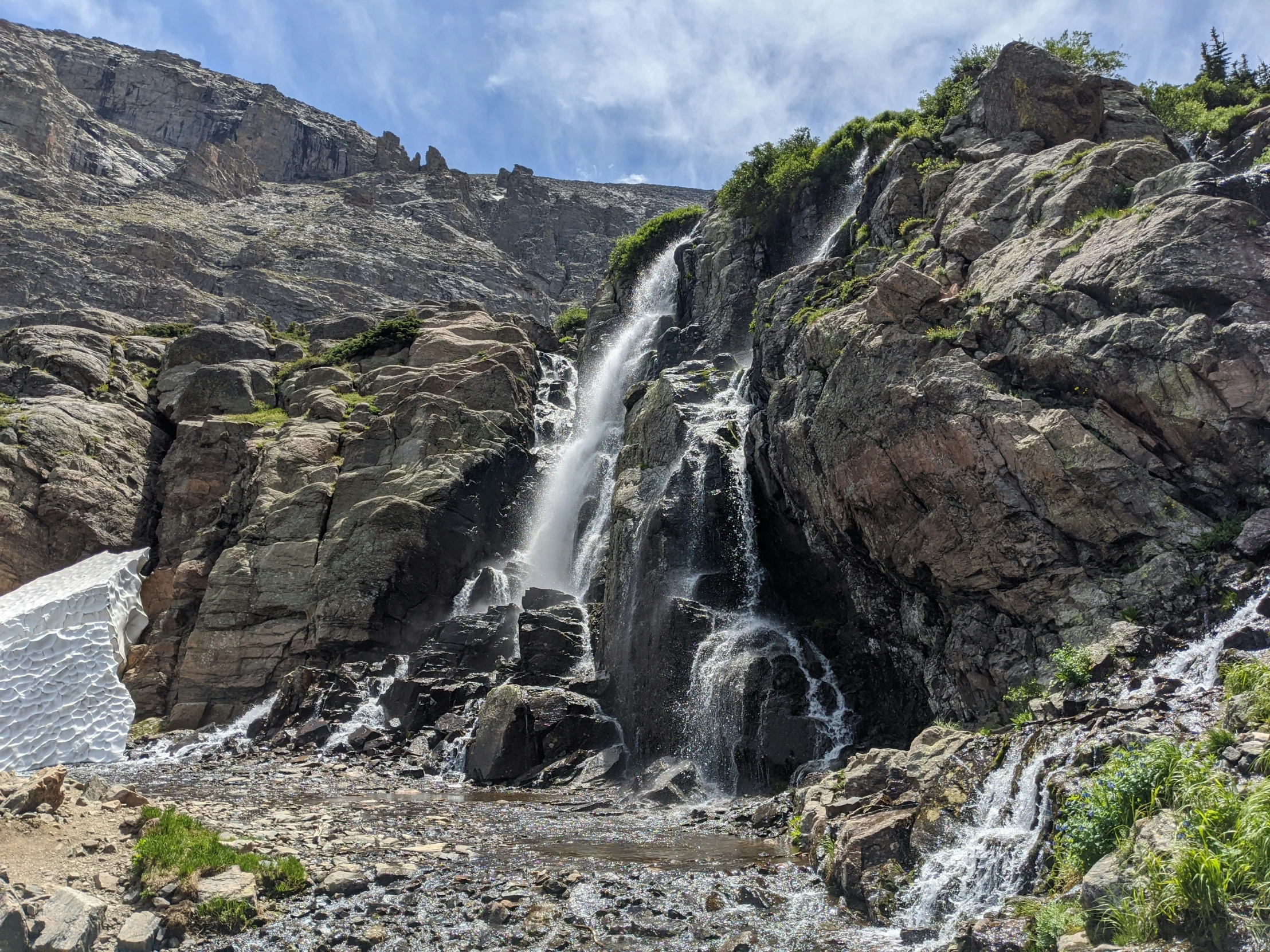 a large waterfall on the side of a mountain