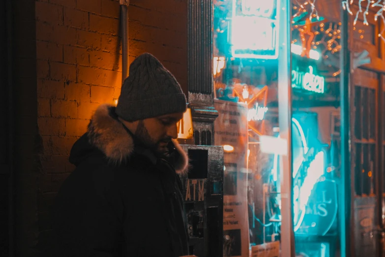 a person standing outside in front of a neon sign