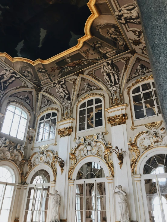 the interior of an ornate building with carved statues and windows