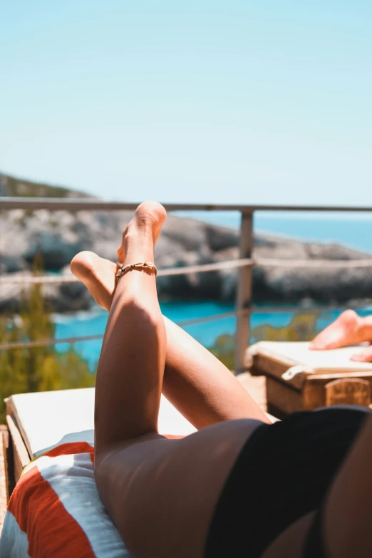 people laying down on a deck looking out at the water