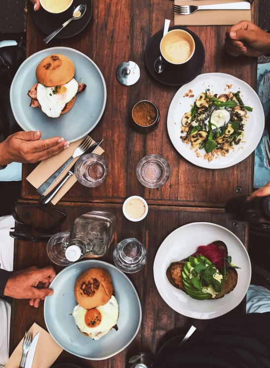 a group of people eat from plates of food