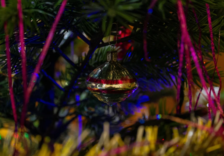 a ornaments hanging from the top of a christmas tree