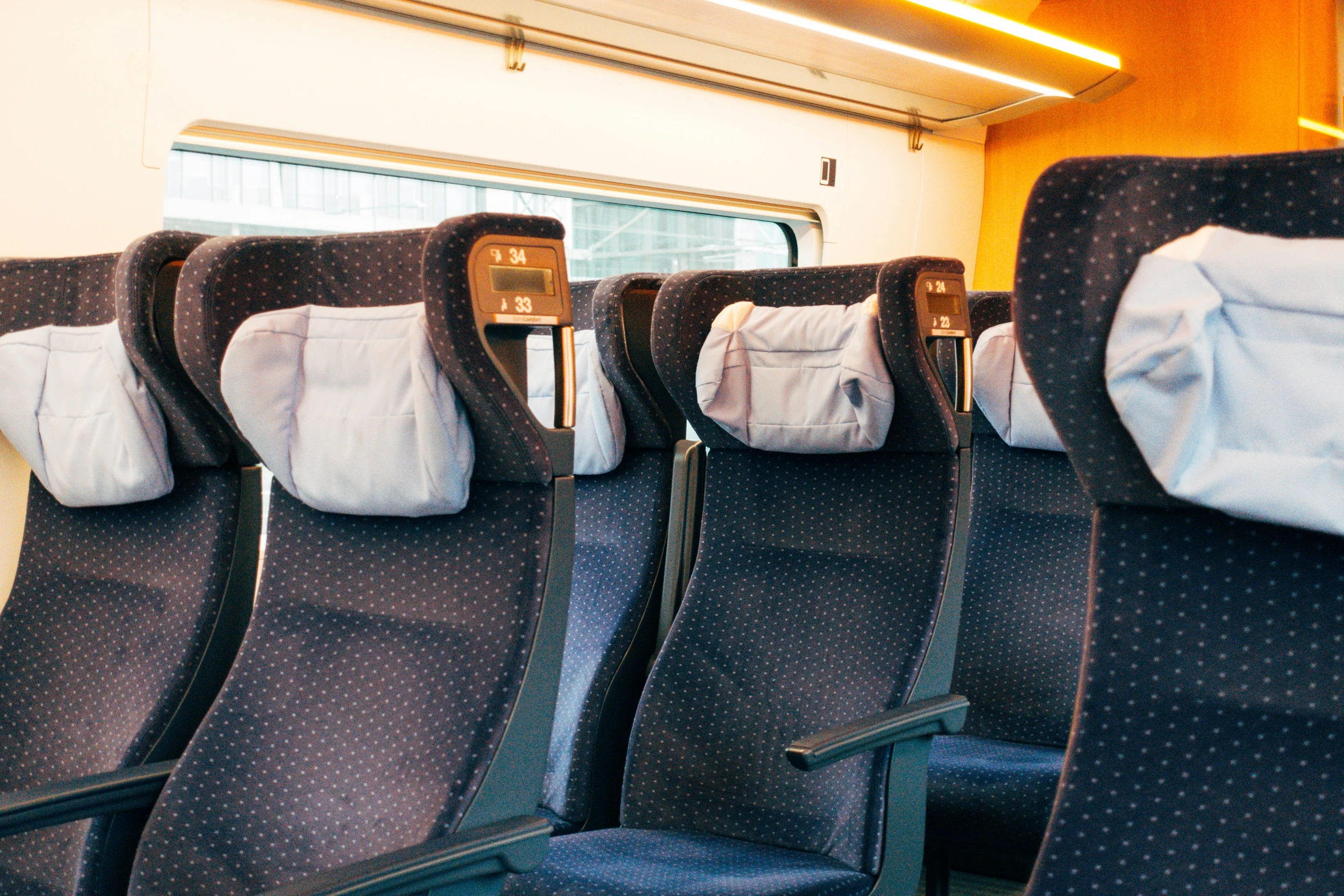 an empty train carriage with blue and gray seats