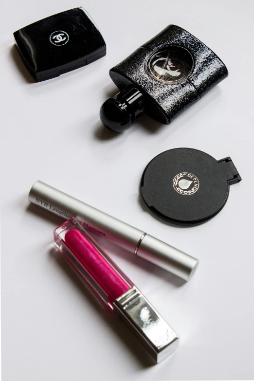 a close up of a bottle of lipstick and some other items