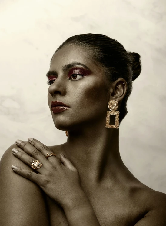 a woman with make up and earrings on