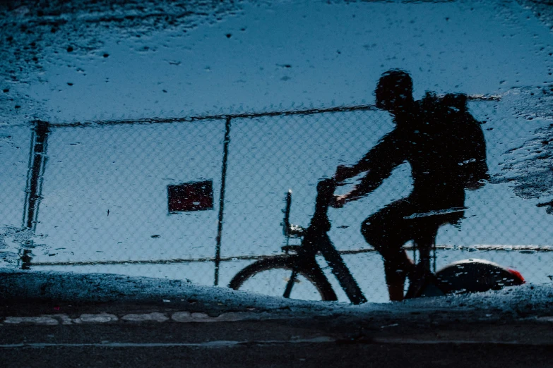 a man is riding a bike outside in the winter