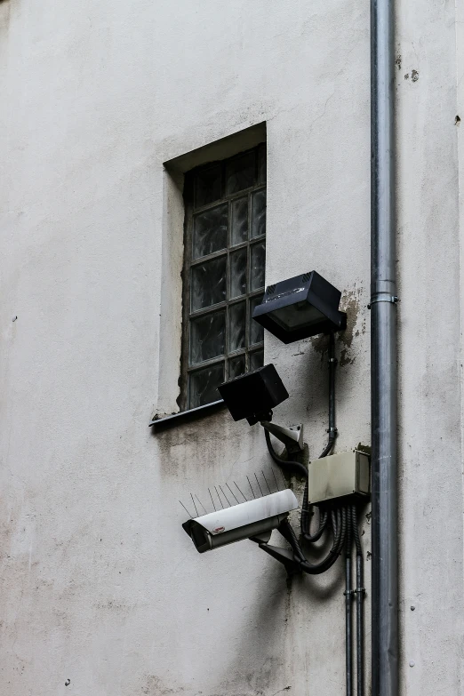 a camera is attached to the side of a white wall