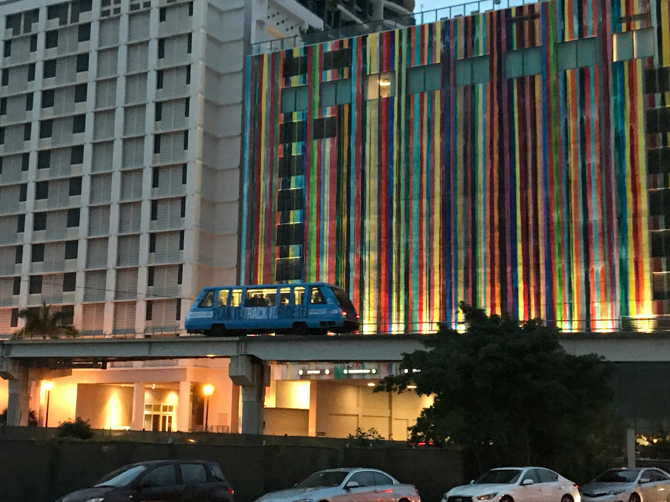 a large tall building with a multicolored covering over the top