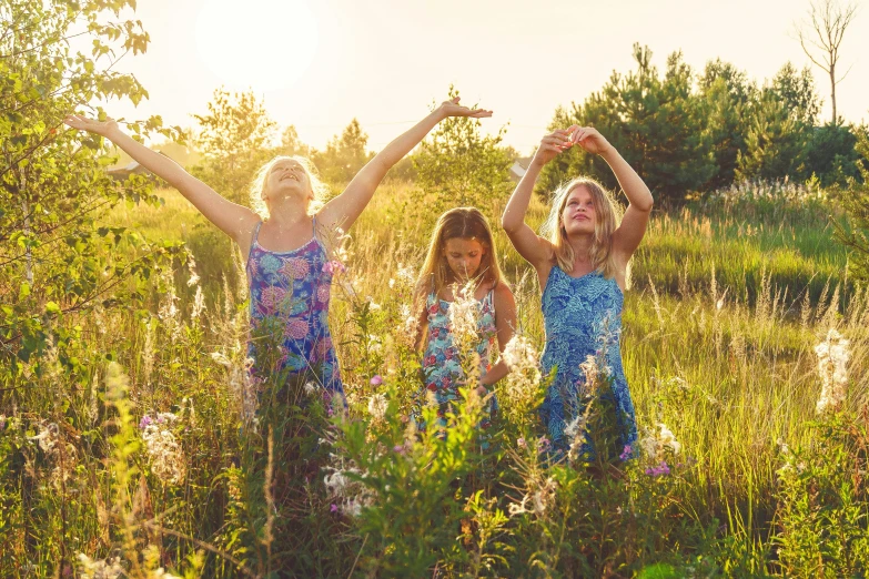 a group of young children standing in a field