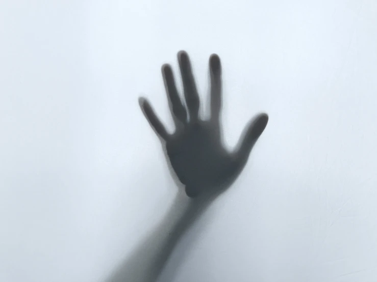 an extended hand reaching up to reach the floor