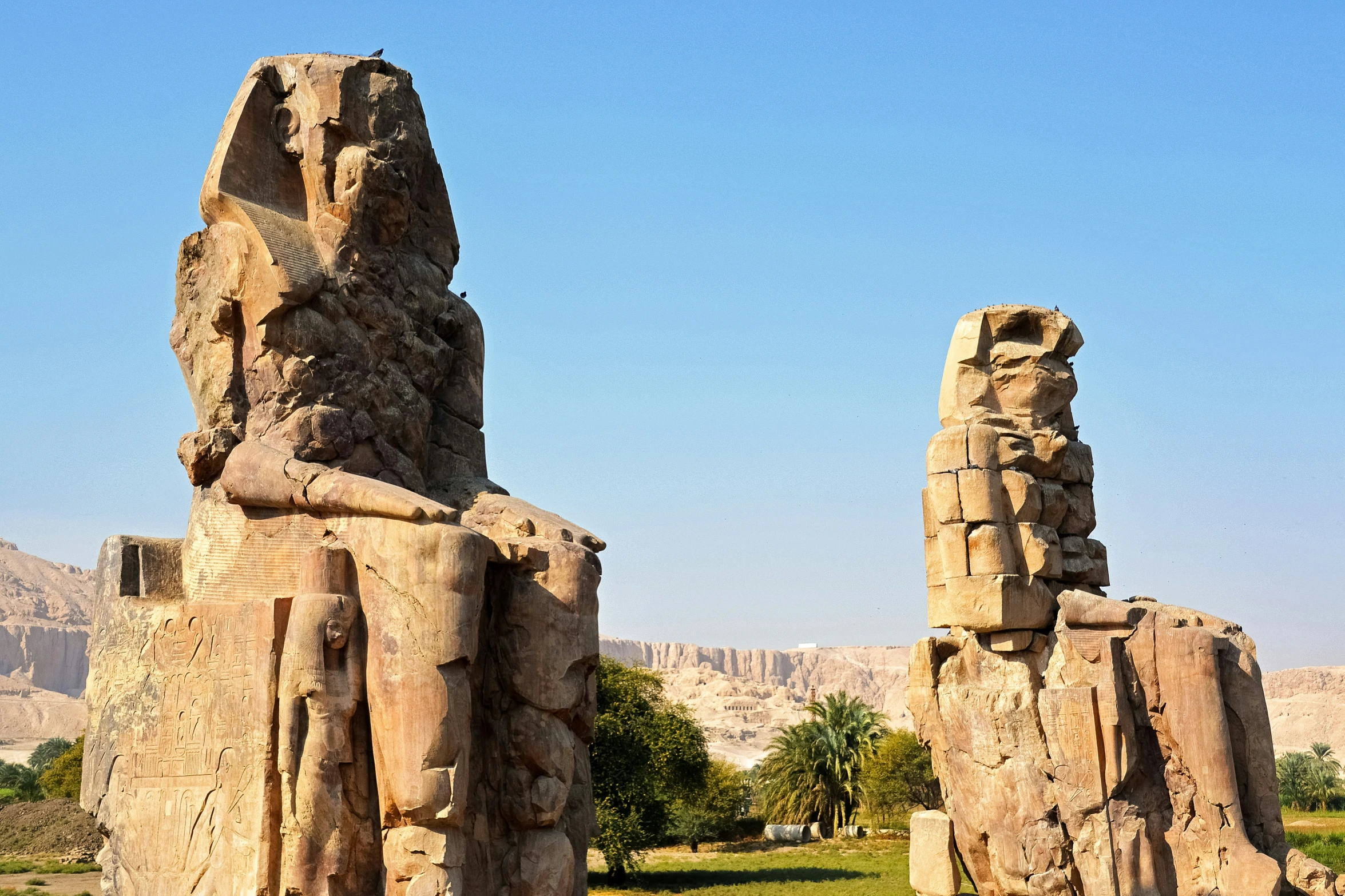 two large stone columns in the middle of a field