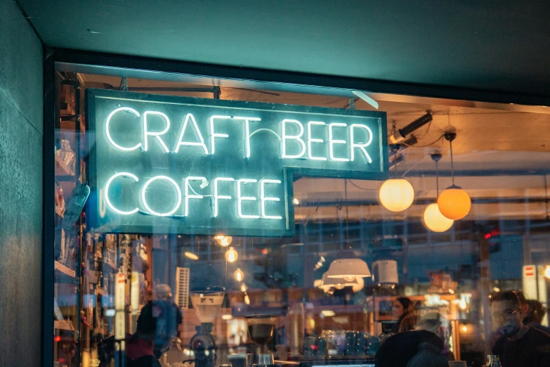 neon sign sitting in the window of a coffee shop