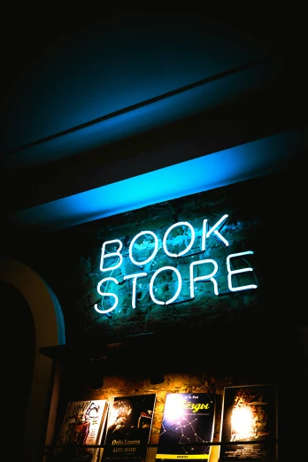 a book store sign lit up in the dark