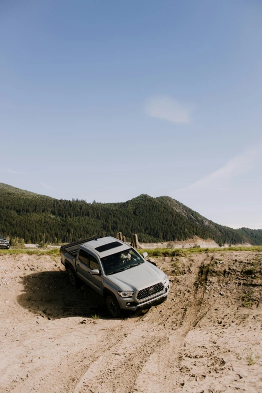 there is a car that is parked on the sand