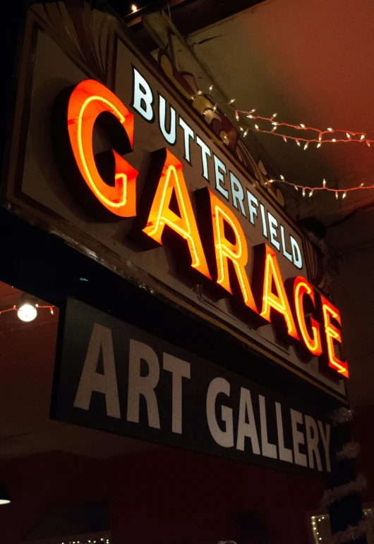 lighted signs are above a bar at a garage